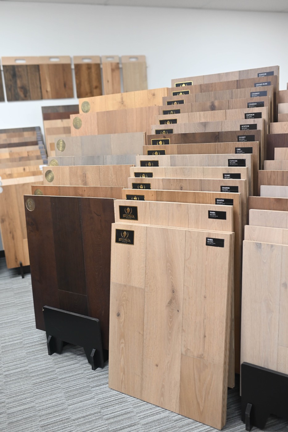 Edges of engineered hardwood sample boards showing the layered core