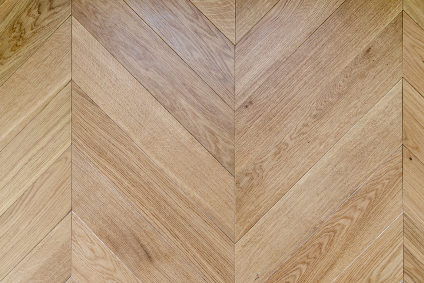 French oak laid in a chevron pattern, pale natural finish with visible grain