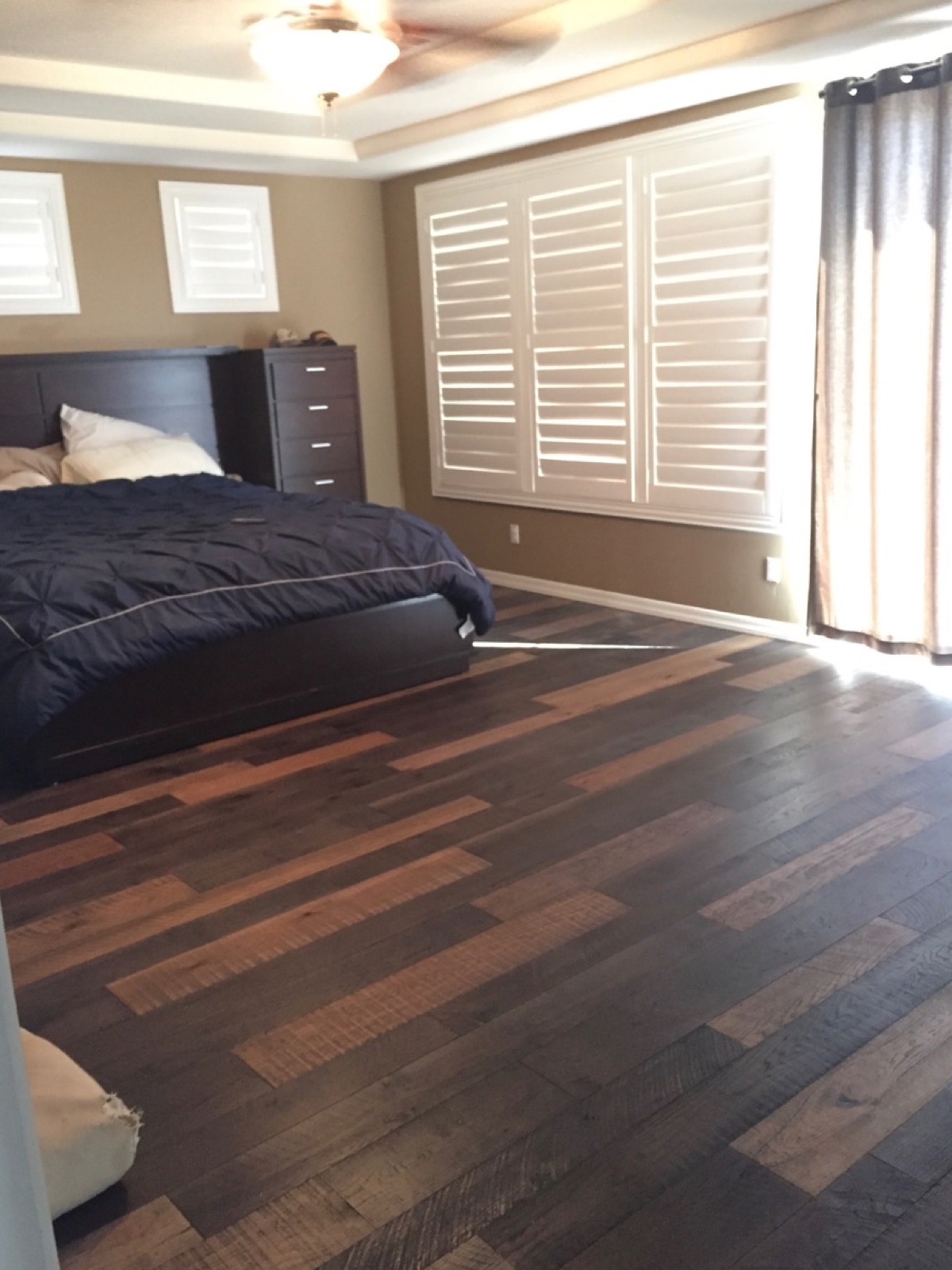 Master bedroom with a multi-tone mixed-width hardwood floor