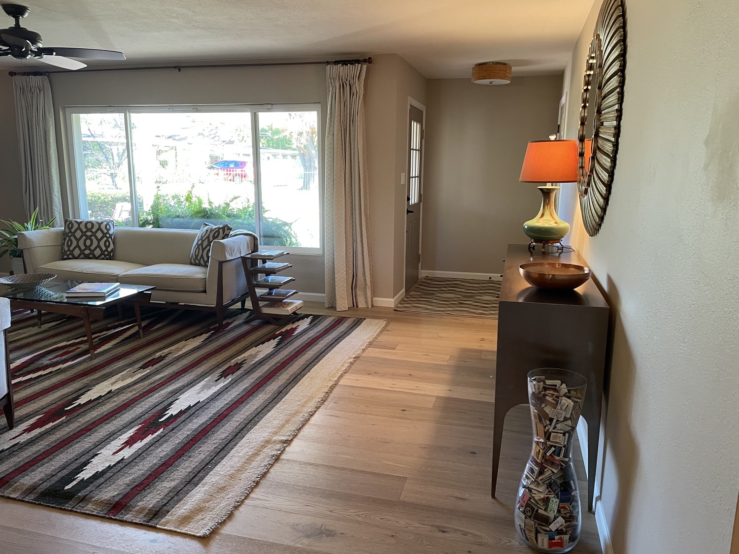 Finished hardwood entry running into a living area
