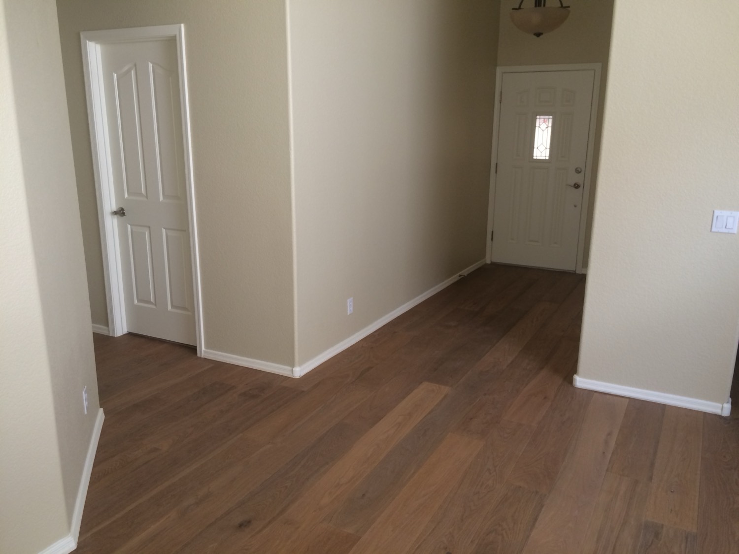 Finished wide plank hardwood floor in a Phoenix house handed over clean