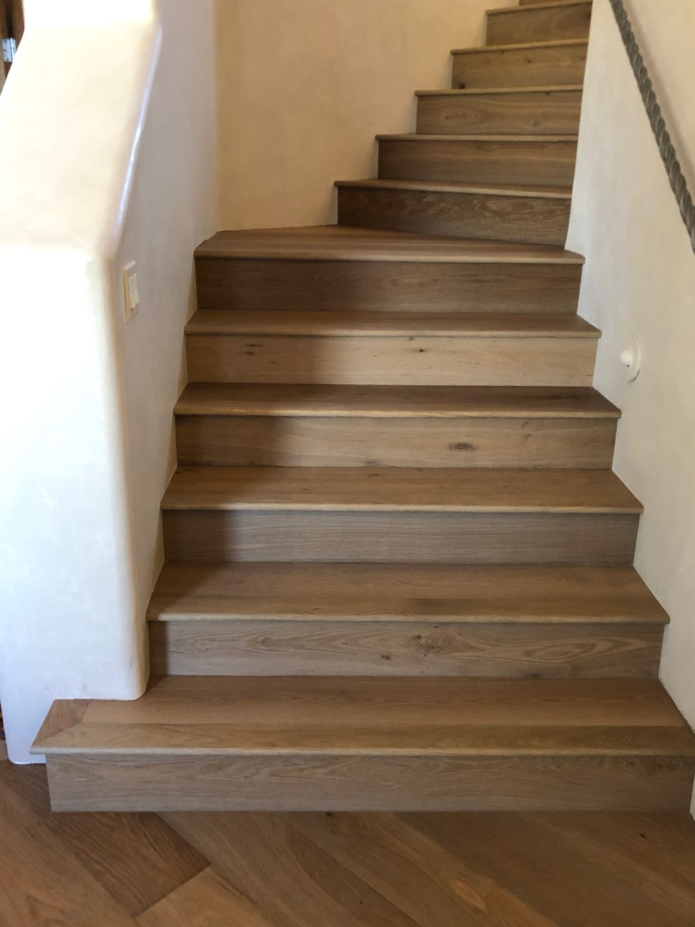 Staircase mid-installation with treads and risers being fitted