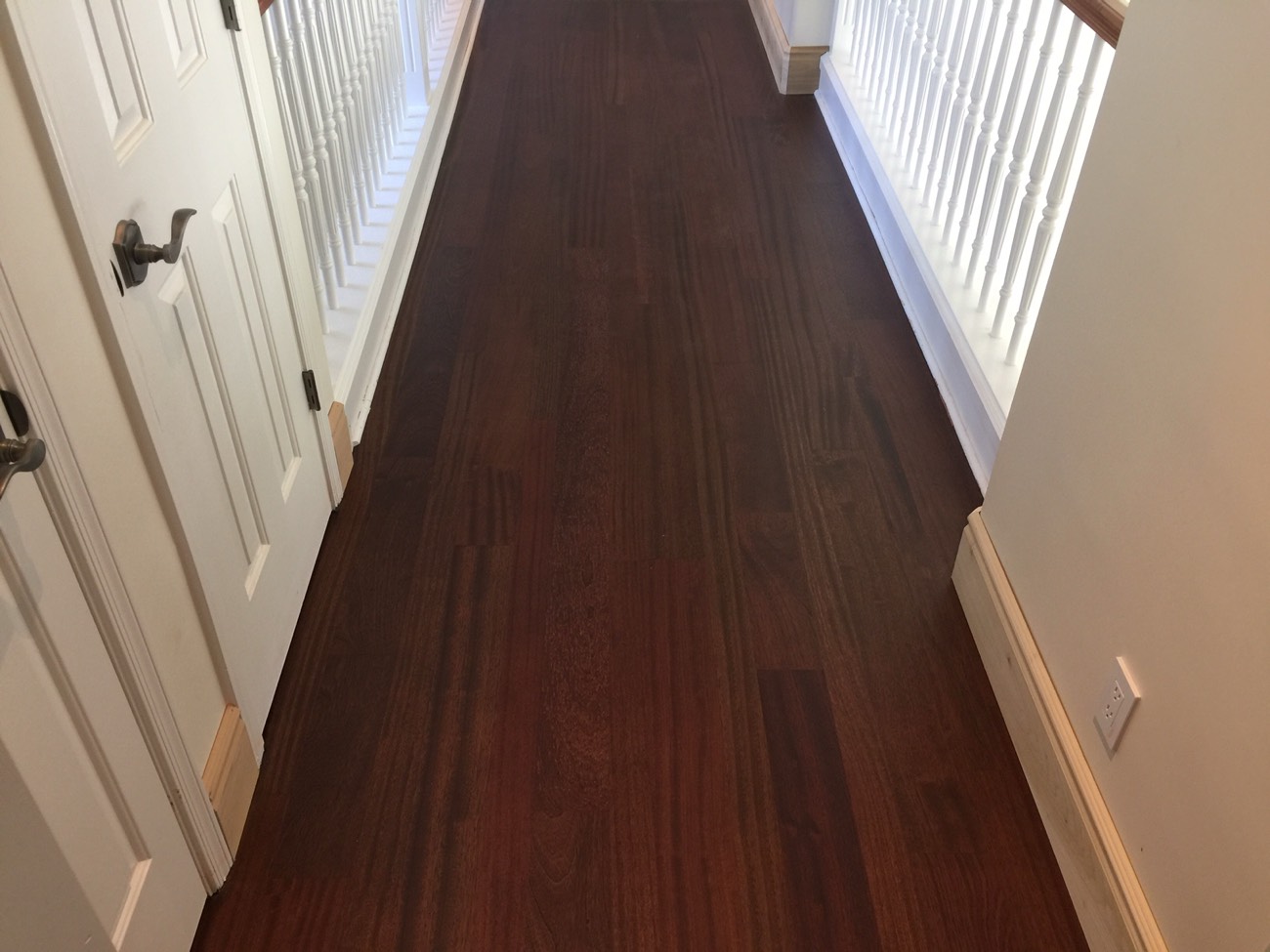 Dark refinished hardwood hallway with a low-sheen finish