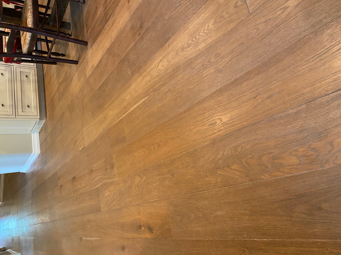 Refinished warm oak floor catching afternoon light in a Phoenix house