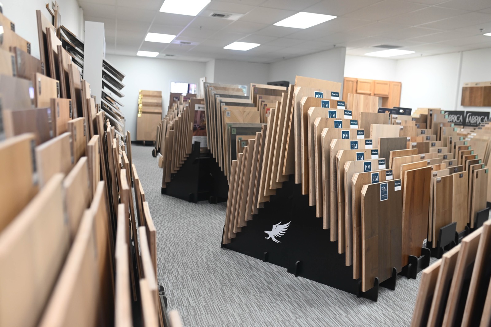 Narrow aisle between tall racks of hardwood samples