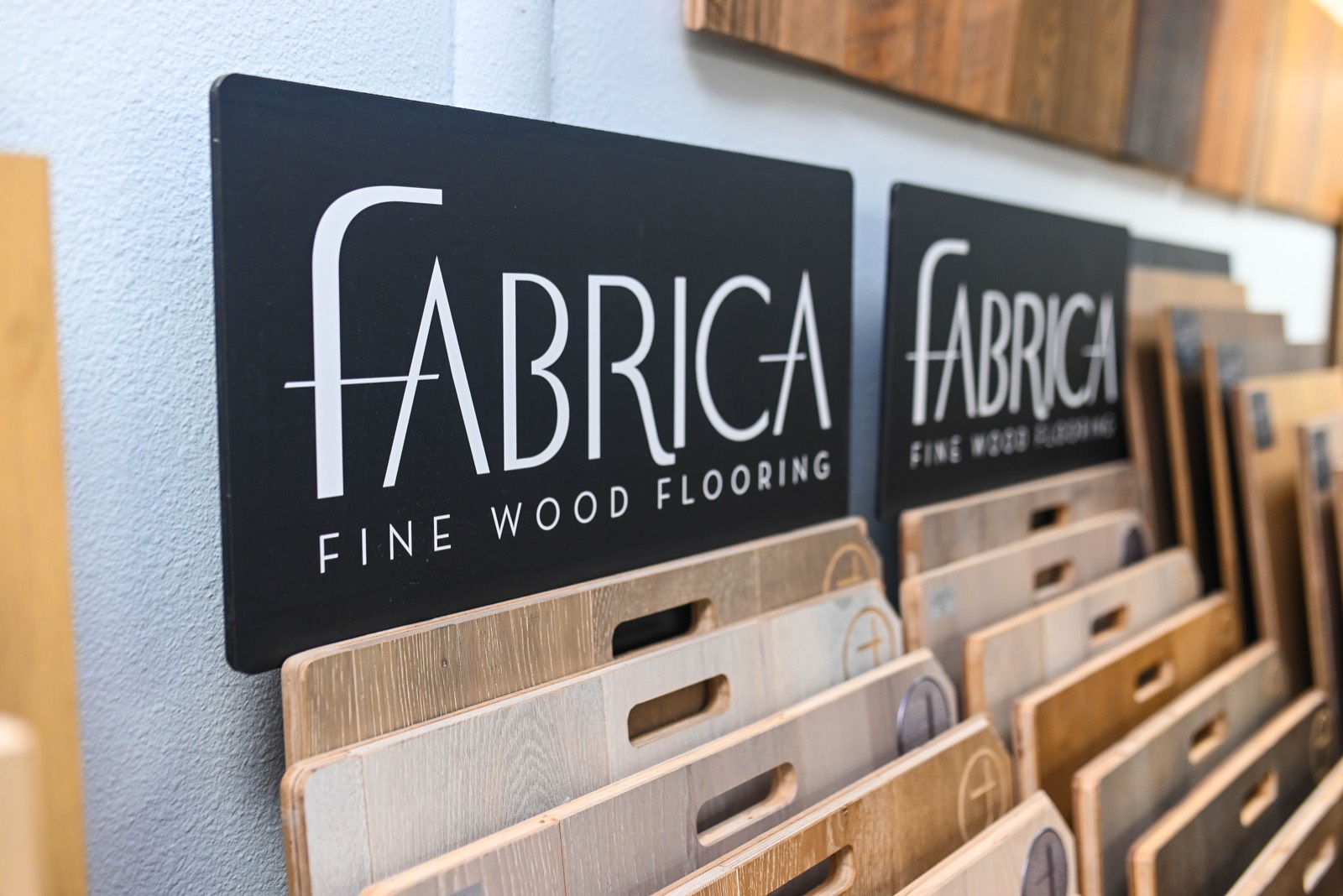 Fabrica signage above a display of fine wood flooring samples