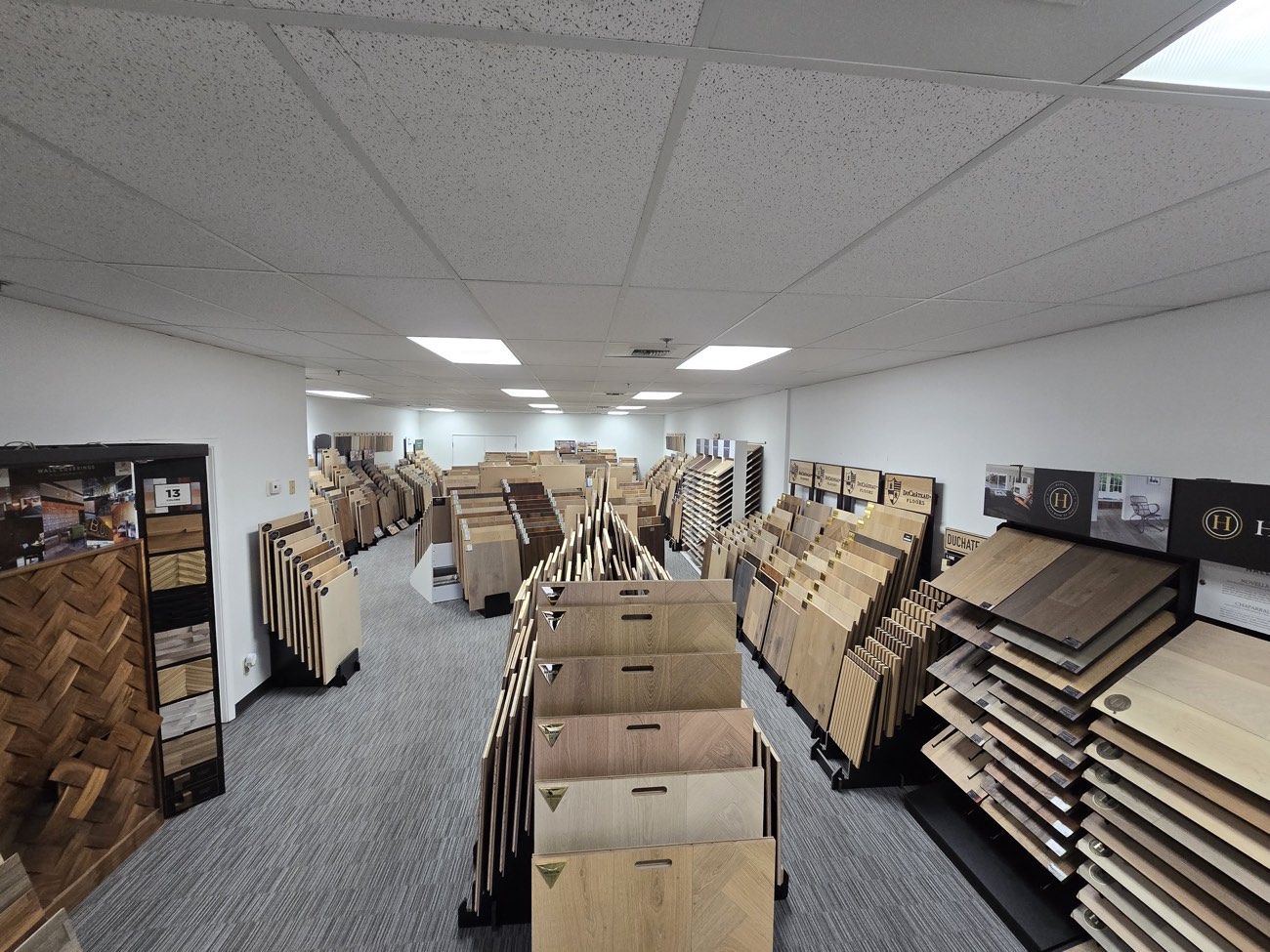 Showroom floor seen from the far end, racks on both sides