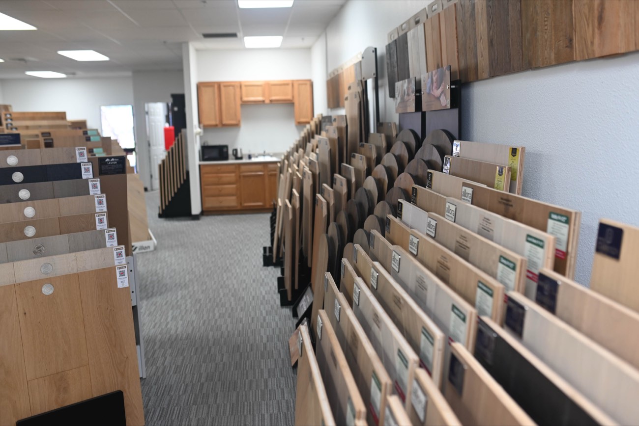 Long aisle of hardwood sample racks receding into the showroom