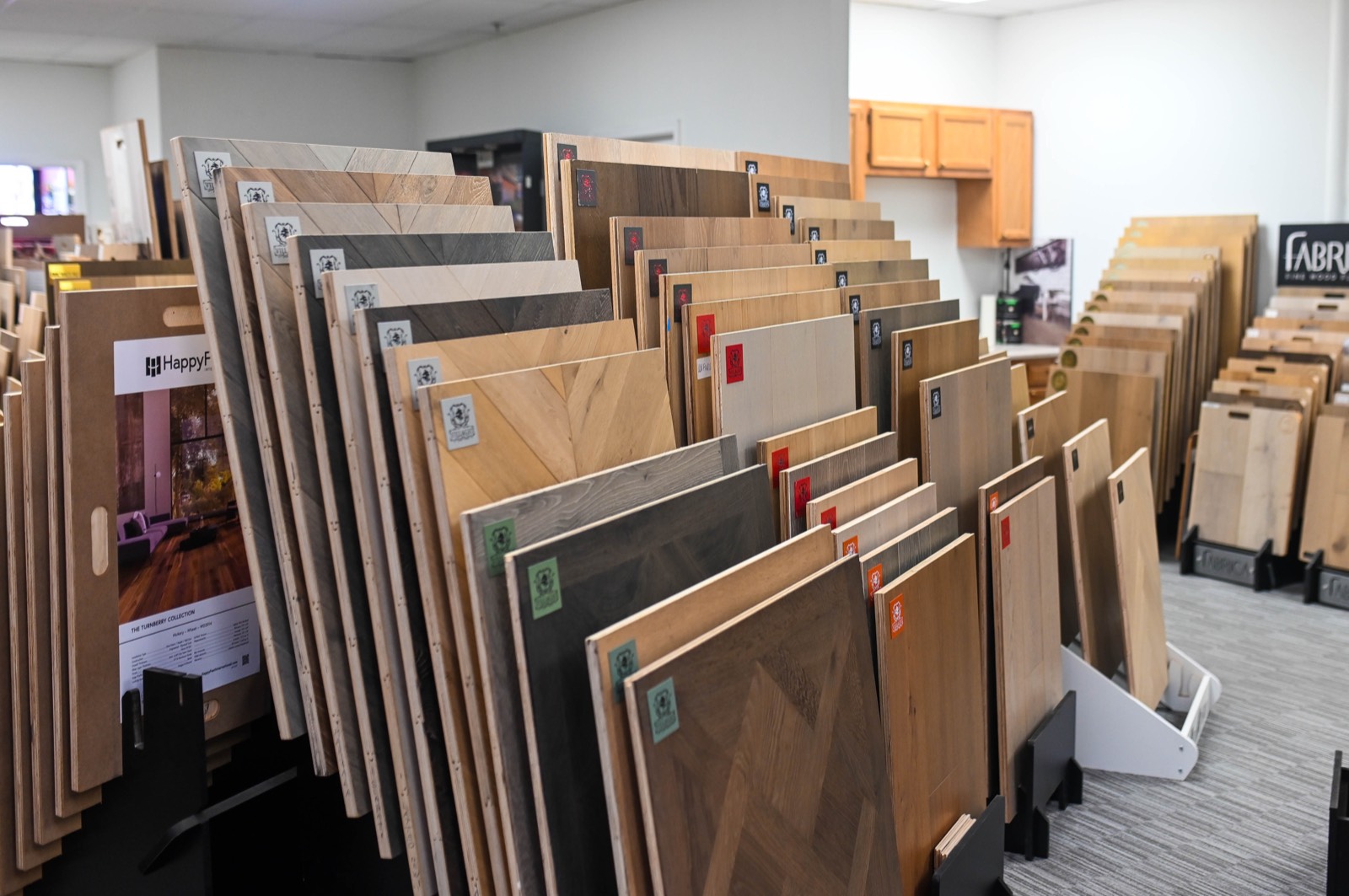 Herringbone and chevron pattern samples displayed among plank boards in the store