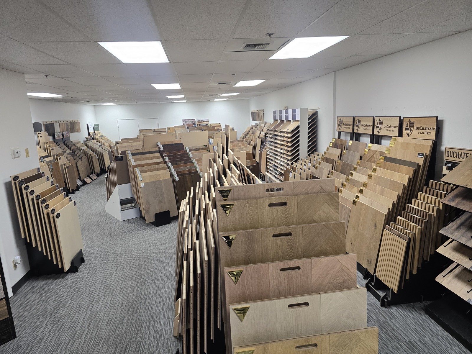 The showroom from the entrance, sample racks filling the space