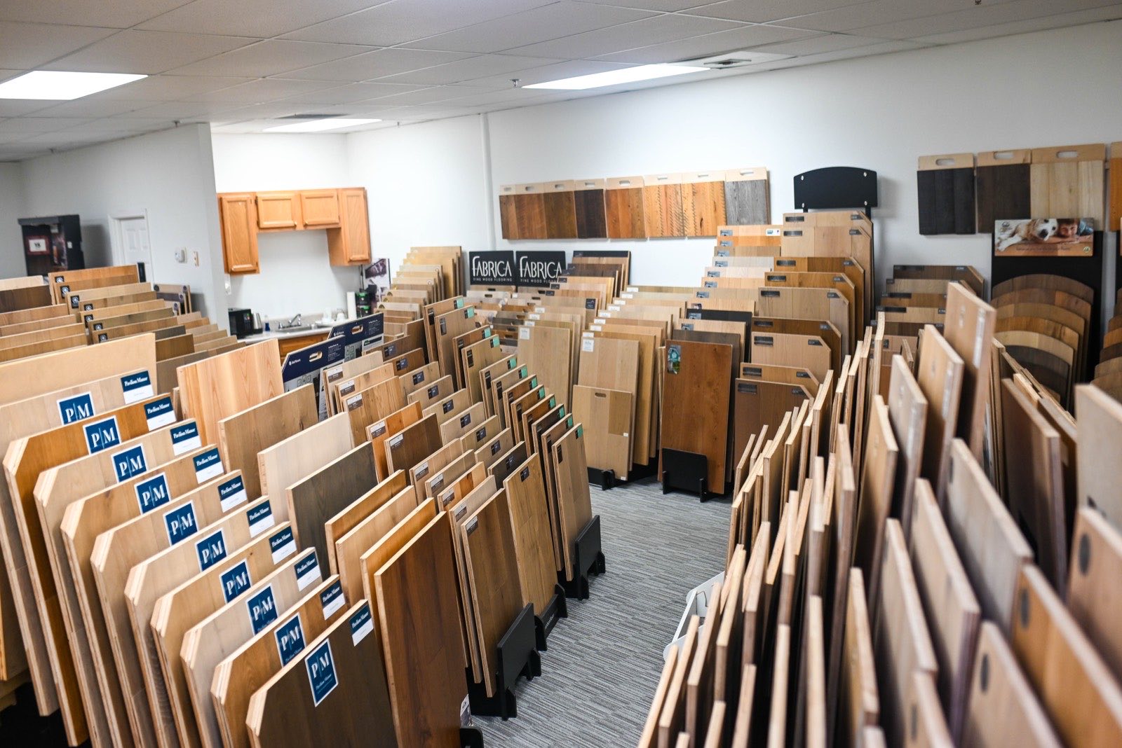 Rows of hardwood sample boards standing in the Olympic showroom racks