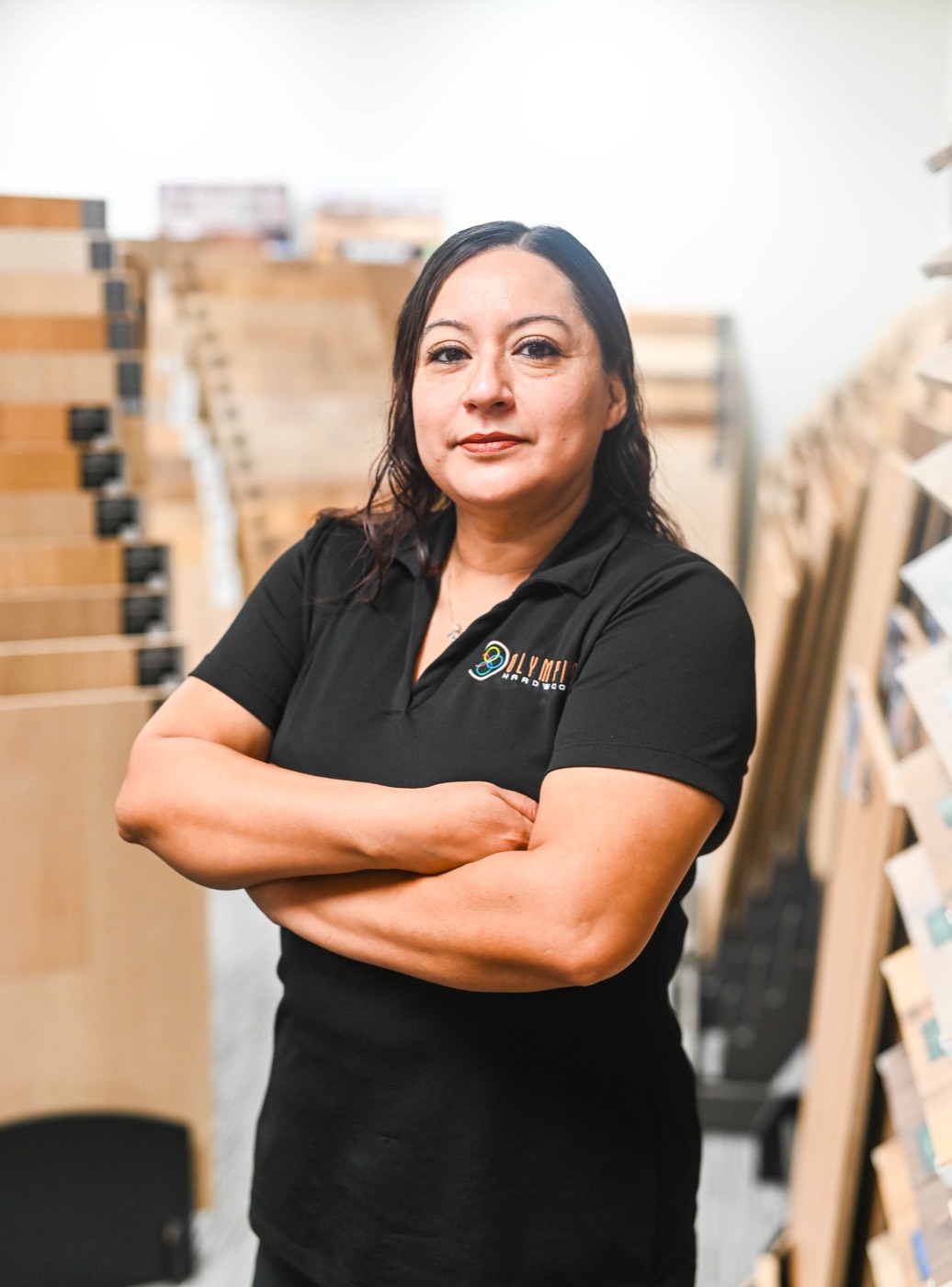 Member of the Olympic showroom team standing among the sample racks