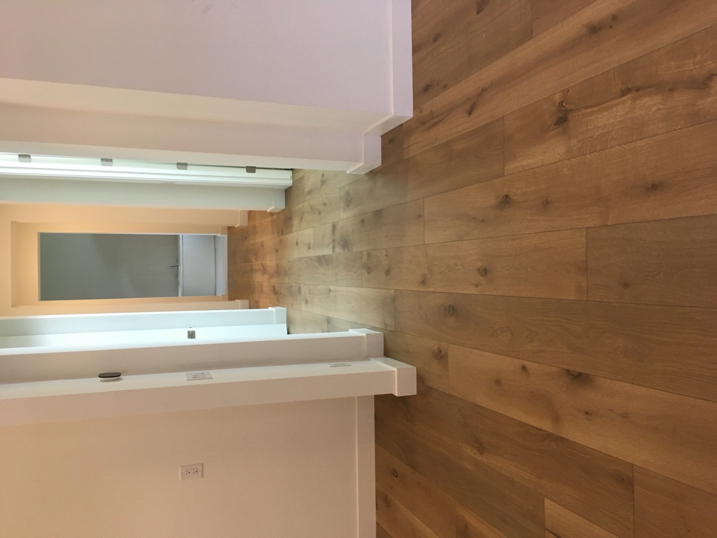 Finished hardwood hallway in a Phoenix home after tile removal and slab preparation