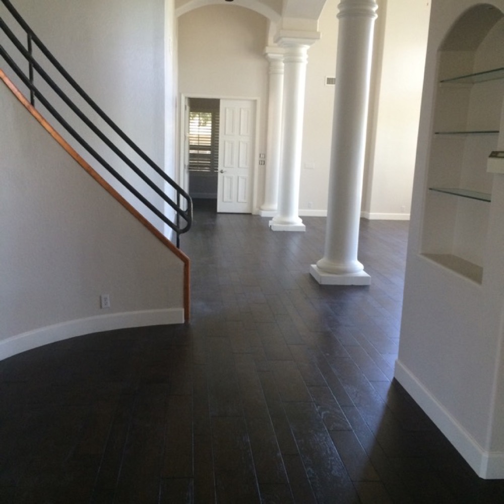 The same great room finished with dark hardwood flooring